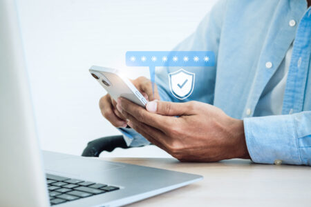 Two factor authentication concept. Virtual safety shield icon while access on phone with laptop for validate password, Identity verification, cybersecurity with biometrics authentication technology.