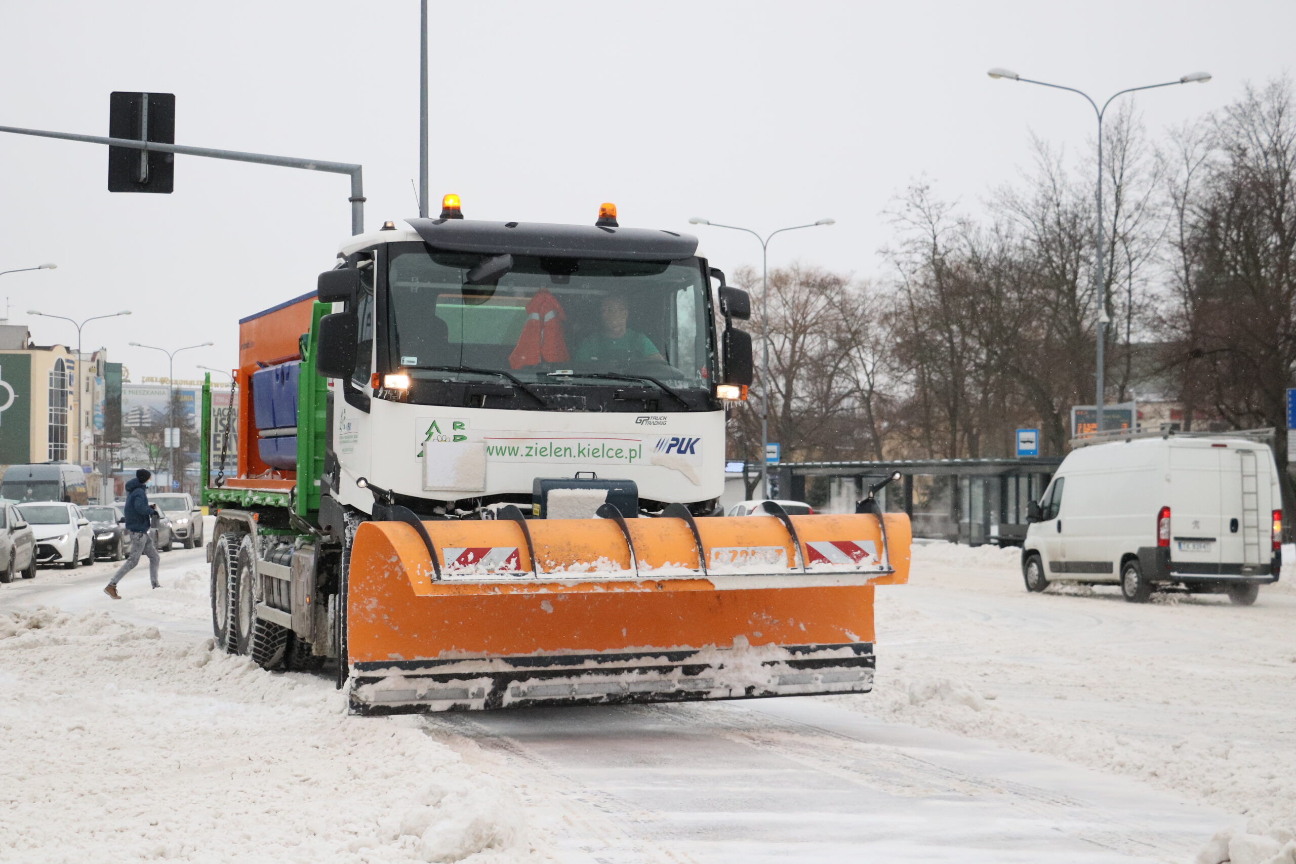 Zdjęcie przedstawia pługopiaskarkę na ulicy w Kielcach